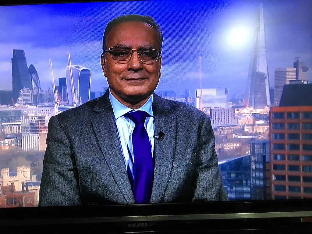 Dr Wafik Moustafa in a television studio overlooking the London skyline